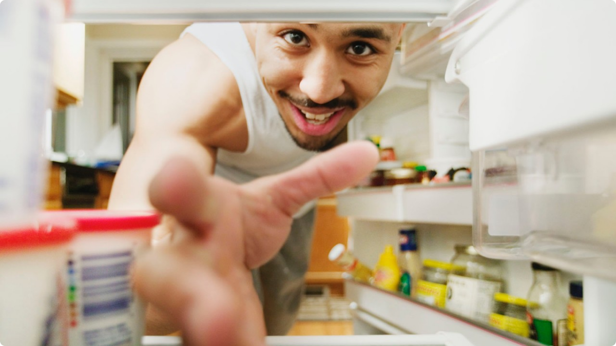 072314-health-healthy-foods-to-have-in-your-fridge-man-looking-Refrigerator-food.jpg